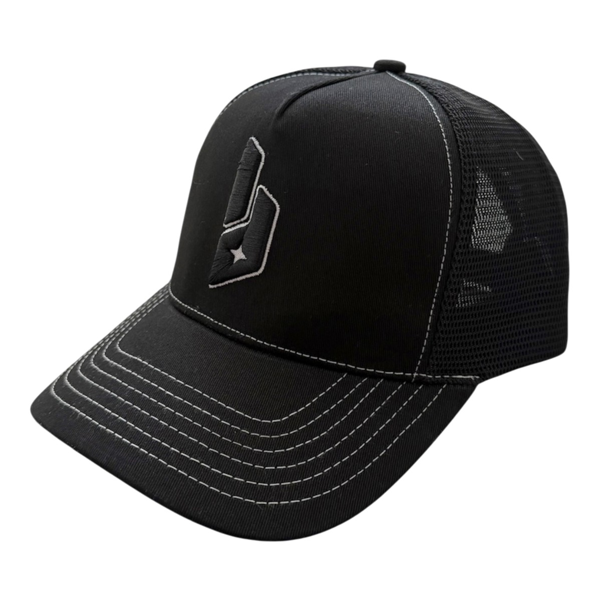 A black trucker-style baseball cap with a curved brim, black mesh back panels, and white contrast stitching. A stylized black logo with a white star is embroidered on the front panel.