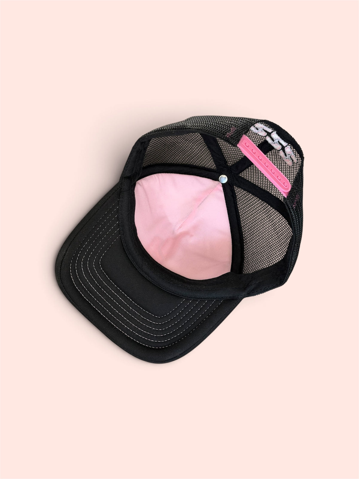 Pink underlay front panel, pink stitching on brim, pink adjustable strap on rear and pink 222 on rear embroidered with white stars.